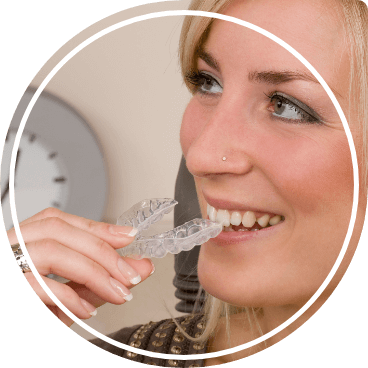 Blonde woman receiving Invisalign clear aligner from her dentist