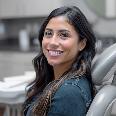 Woman smiling while sitting in treatment chair