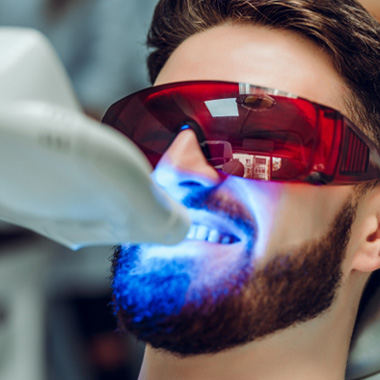 Man having teeth whitened at dental office